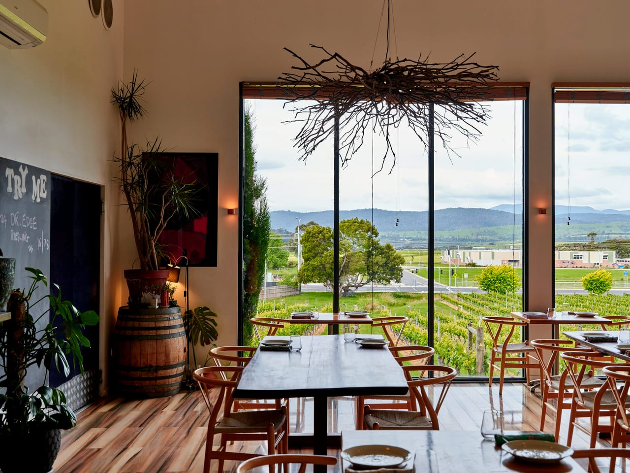 A restaurant dining room with a vineyard view.