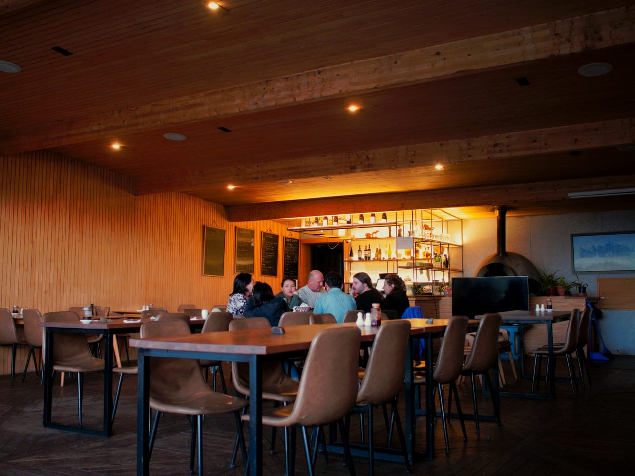 A cosy restaurant with a well-stocked bar and diners