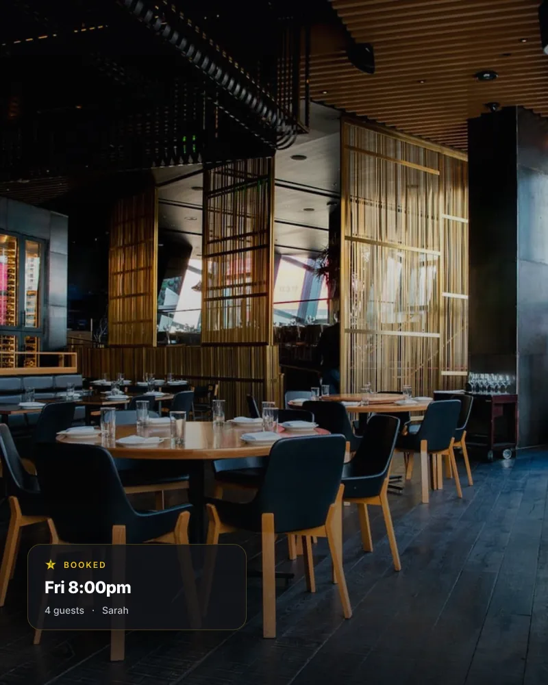 A dim restaurant interior at service time, with a floating VoxTable booking card reading 'Booked · Friday 8:00pm · 4 guests · Sarah'.