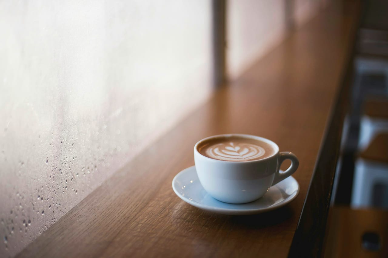 A cup of coffee on a saucer on a café table