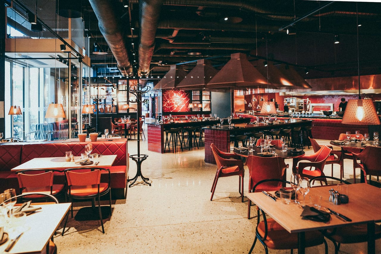 Empty restaurant tables set and waiting for evening guests.
