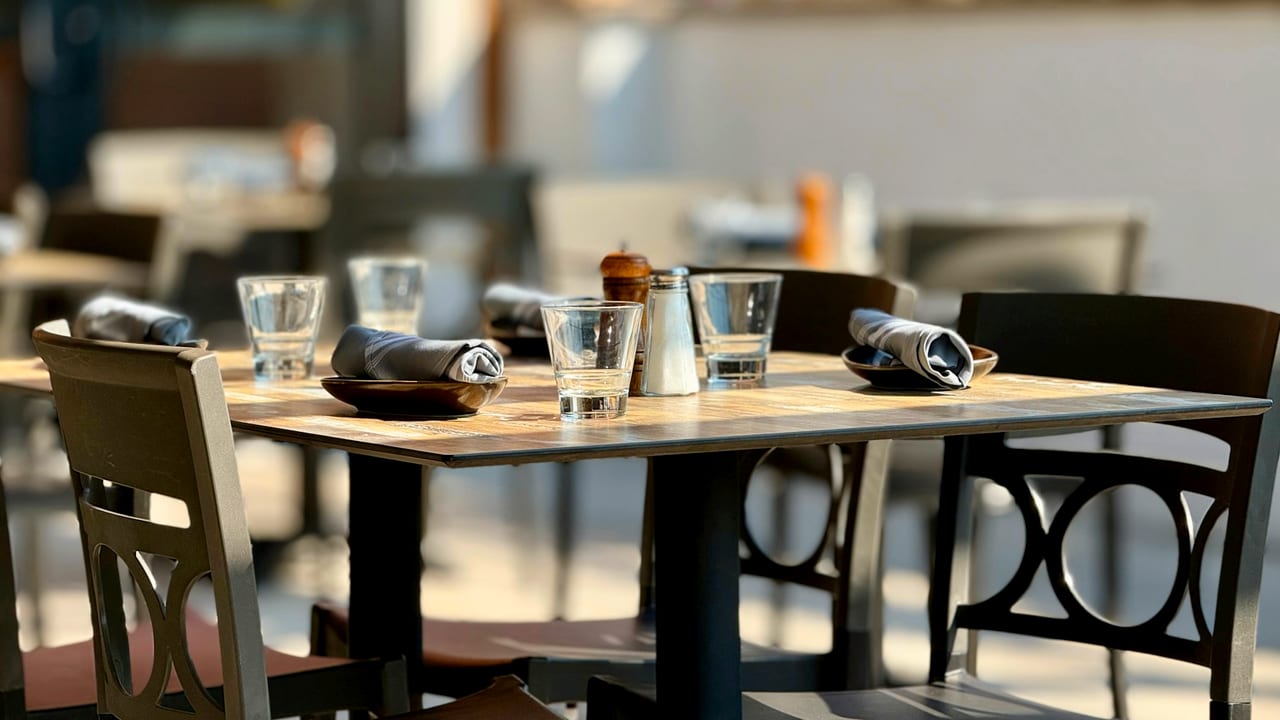 Set dining tables at an outdoor restaurant.