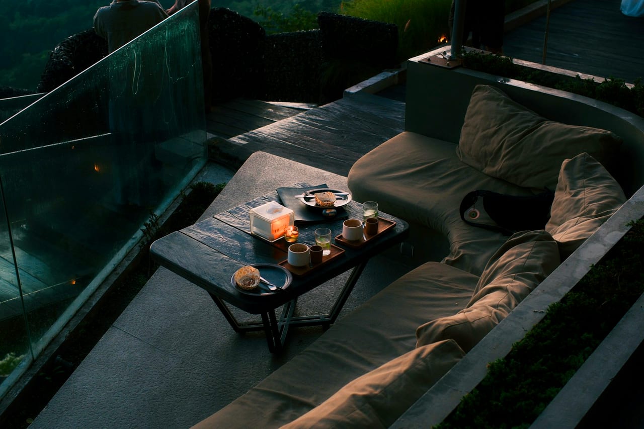 A relaxed outdoor dining table set with refreshments