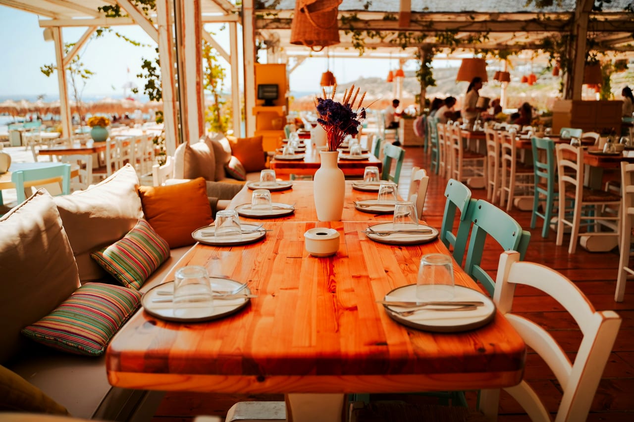 Restaurant tables set for dining with an ocean view