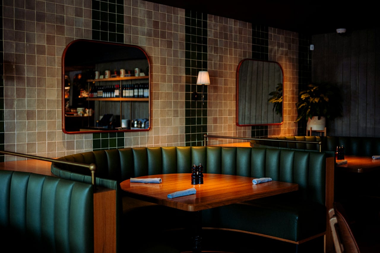A dimly lit restaurant set for service.
