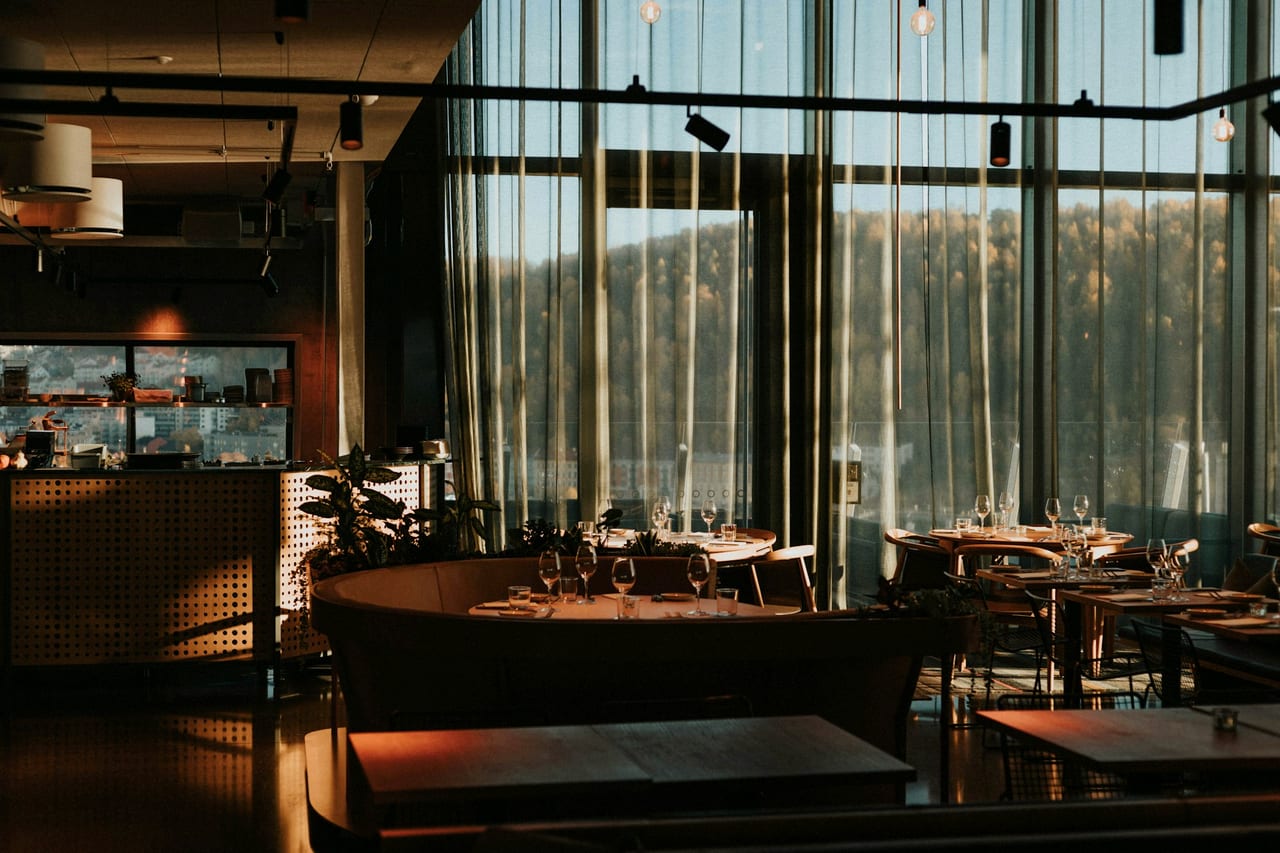 A warm dining room with tables and chairs.