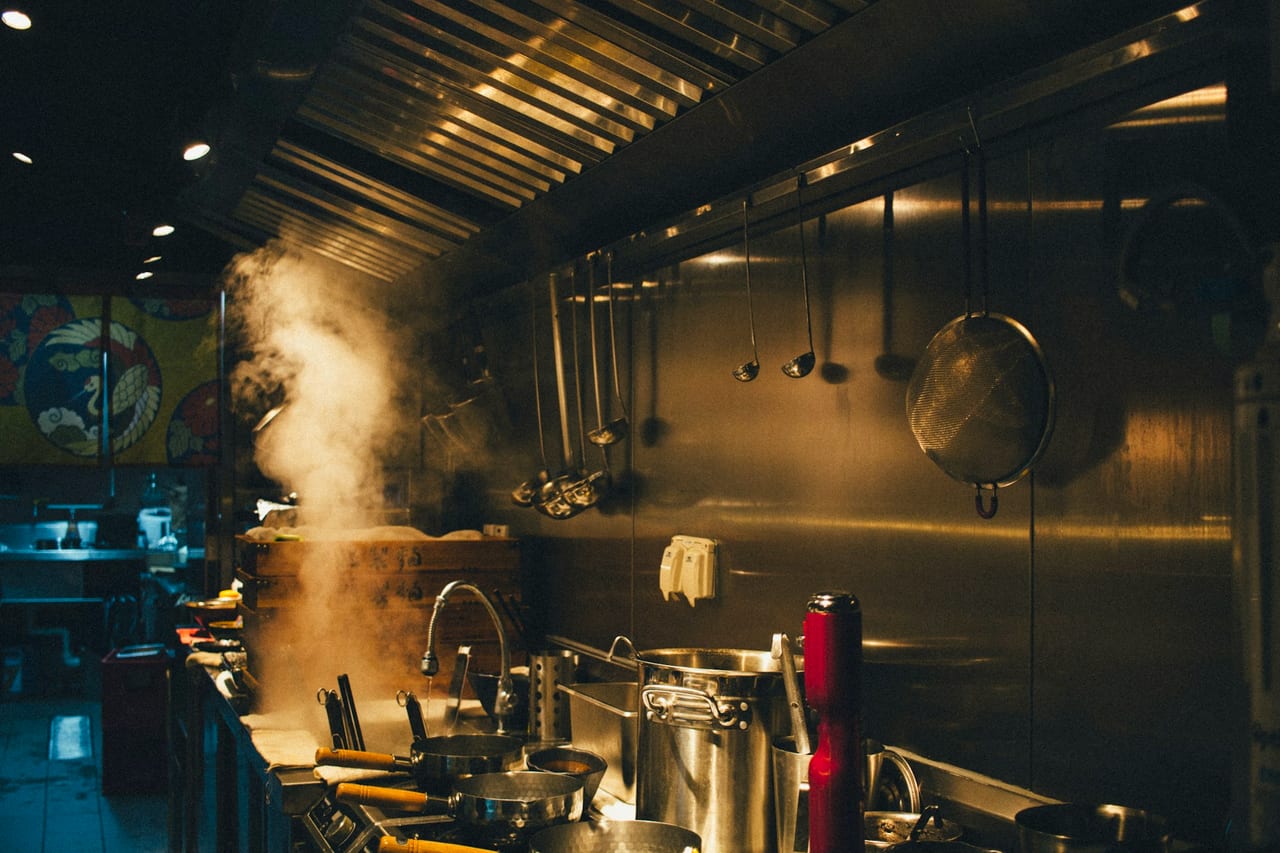 Stainless steel pots on a professional kitchen stove