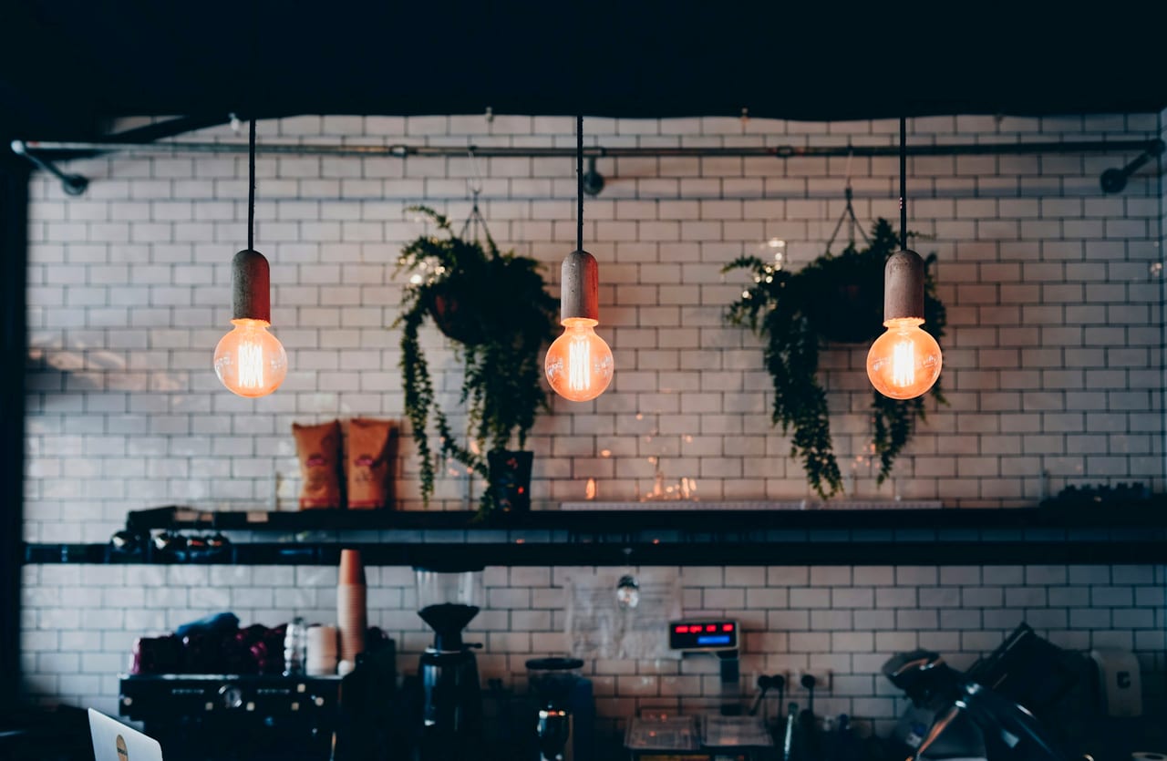 A warm dining room lit by a brown pendant lamp.