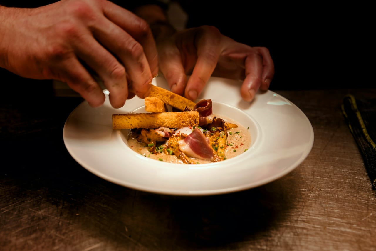 A finished plate of food at the pass, close up.