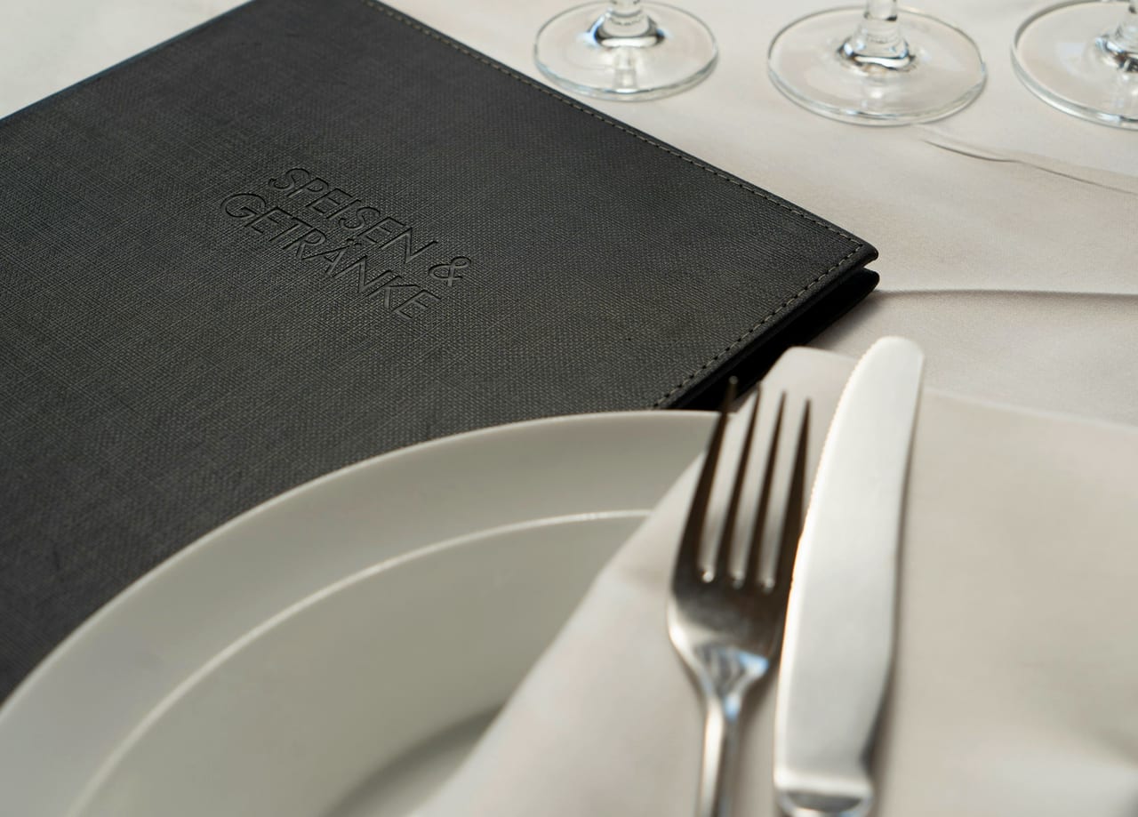 A plated dish with a fork and knife, seen close up