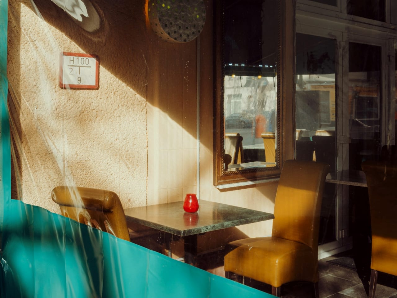 Yellow café chairs at a table in front of a window