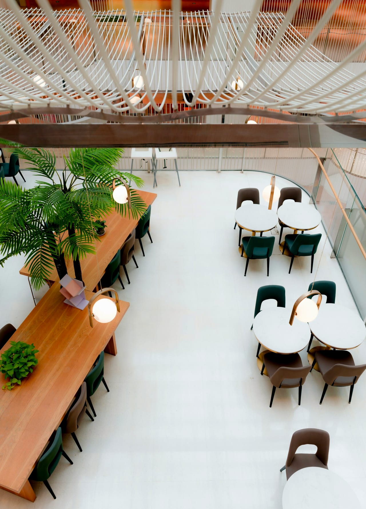 A bright, airy café with a long communal table and greenery, between services