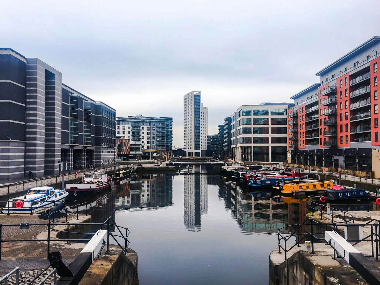 Leeds Dock — narrowboats on still water between brick and glass buildings
