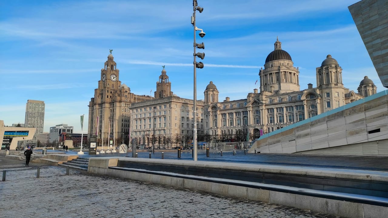 The Three Graces on Liverpool's Pier Head under a blue sky