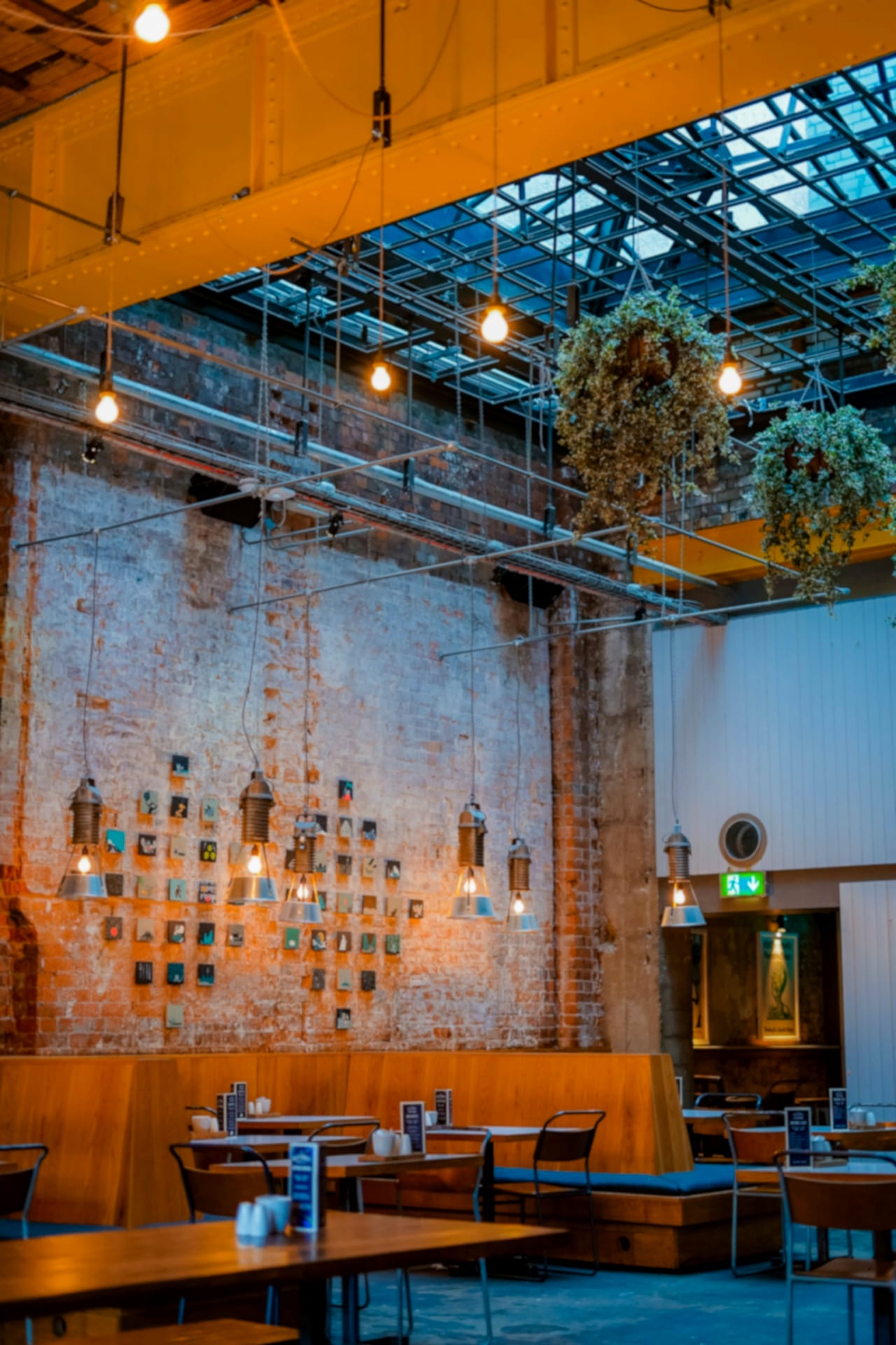 A warm restaurant room strung with soft hanging lights