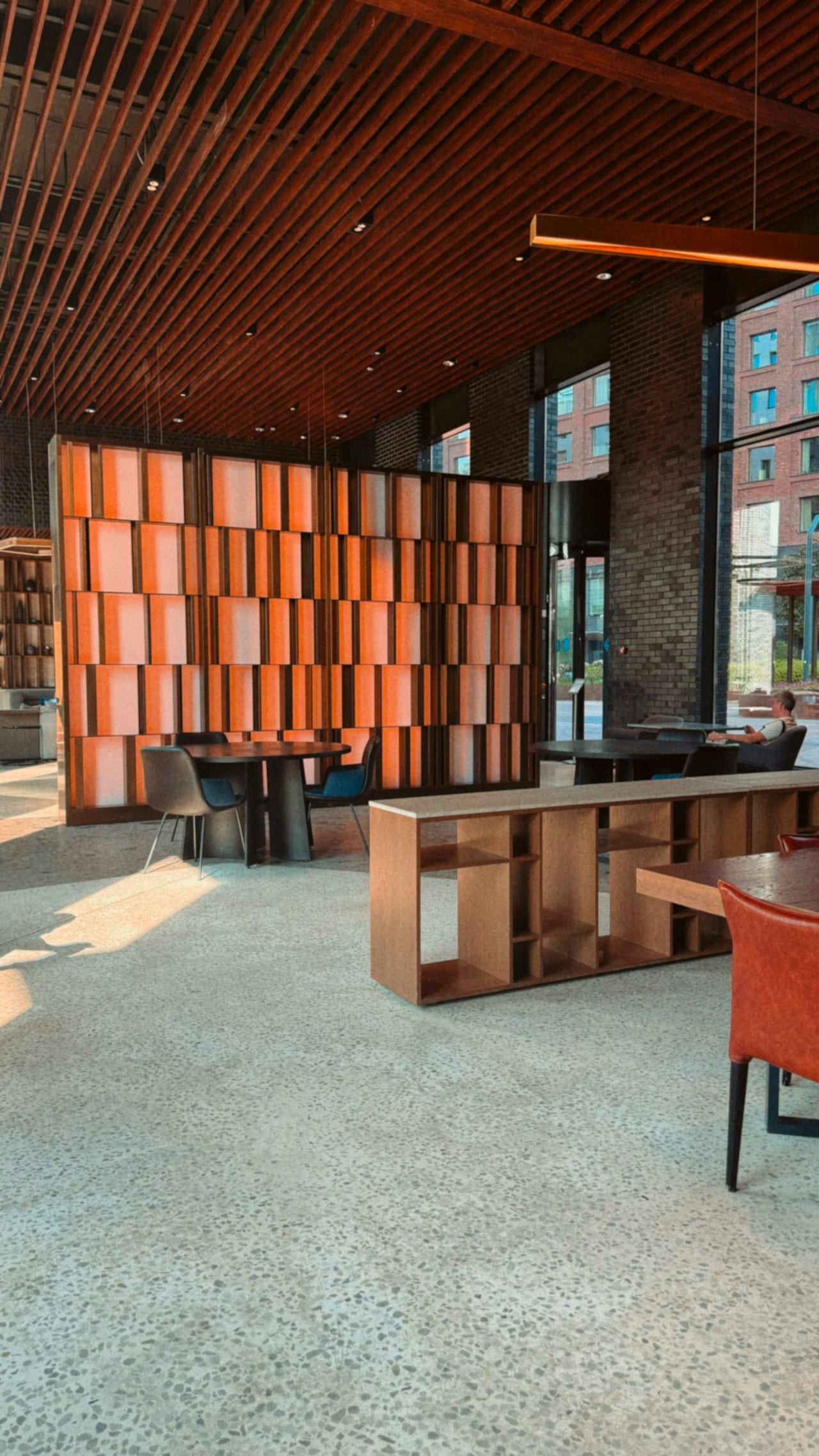 A warm wood-panelled reception lounge with soft seating