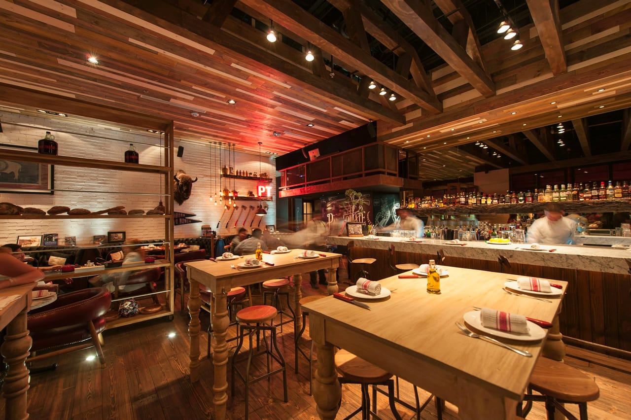 A restaurant dining room set for evening service