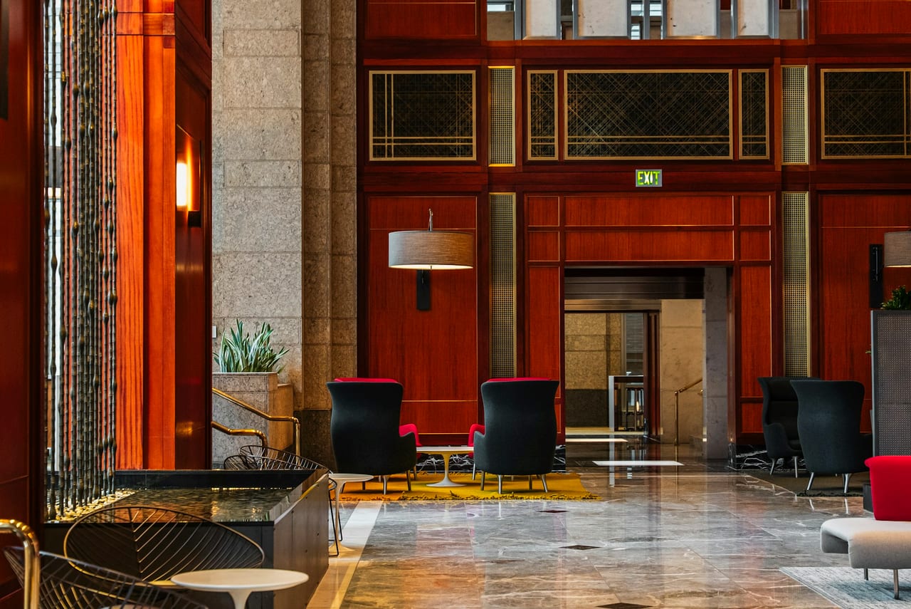 A hotel lobby with wood panelling and seating