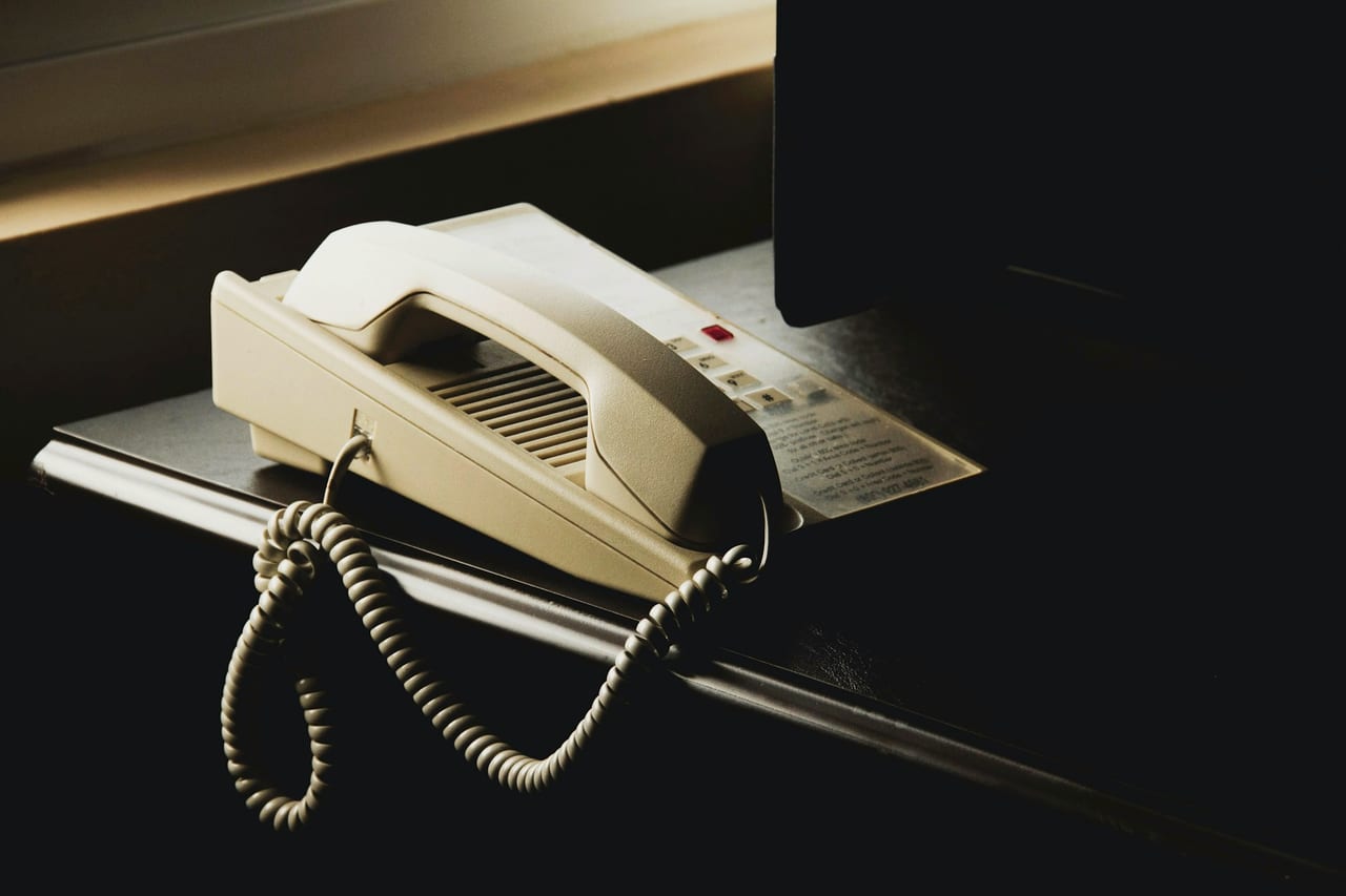 A desk phone on an office reception desk