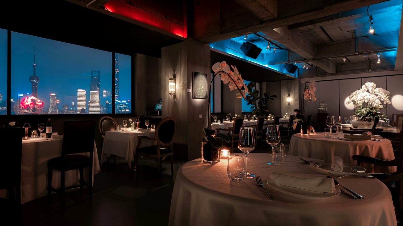 A candlelit restaurant table set for dinner