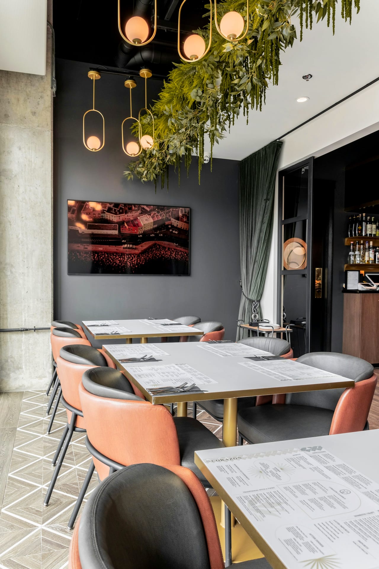 A warm restaurant dining room, tables and chairs