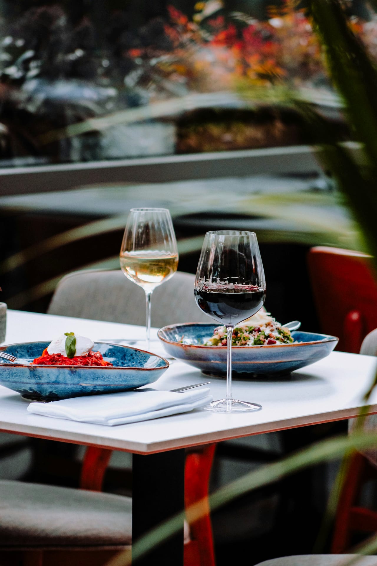 Sharing plates and two glasses of wine on a restaurant table