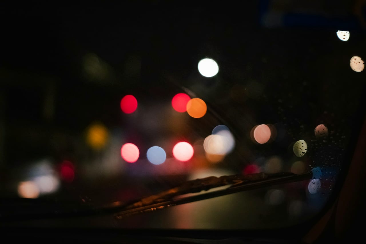 City lights through a windscreen on the road at night